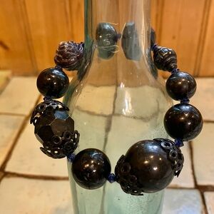 Stretchy bracelet strung with mixed shape black beads.